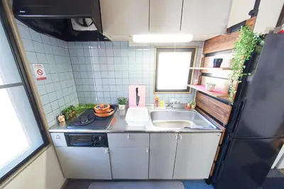 a small kitchen with a sink and a refrigerator at Shamrock Aoto 201 Cozy Tokyo Stay Near Station Airport Disney Access in Tokyo