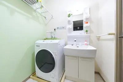 a laundry room with a washing machine and a sink at Shamrock Aoto 201 Cozy Tokyo Stay Near Station Airport Disney Access in Tokyo