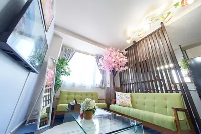 a living room with a couch and a glass table at Shamrock Aoto 201 Cozy Tokyo Stay Near Station Airport Disney Access in Tokyo