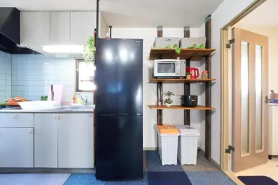 a black refrigerator in a kitchen with a microwave at Shamrock Aoto 201 Cozy Tokyo Stay Near Station Airport Disney Access in Tokyo