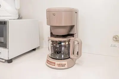a coffee maker sitting on a counter next to a microwave at kamiikebukuro house 4LDK free wifi free parking in Tokyo