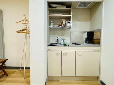 a kitchen with white cabinets in a room at Sugamo hotel 101-TS0333 in Tokyo