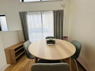 a dining room with a wooden table and chairs at Sugamo hotel 101-TS0333 in Tokyo