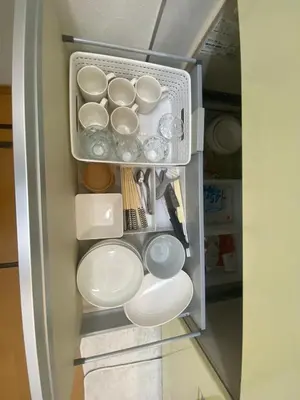 a refrigerator filled with white dishes and utensils at akl\u6771\u745e\u6c5f3\u4e01\u76ee in Tokyo