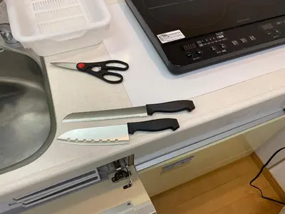 a pair of scissors sitting on a desk next to a monitor at akl\u6771\u745e\u6c5f3\u4e01\u76ee in Tokyo
