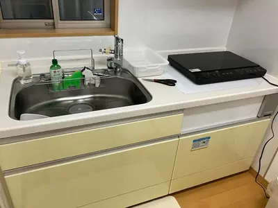 a kitchen sink with a laptop on top of it at akl\u6771\u745e\u6c5f3\u4e01\u76ee in Tokyo