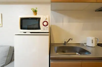 a kitchen with a sink and a microwave at N102 NEW OPEN IKEBUKURO FREE WiFi MAX7GUESTS in Tokyo