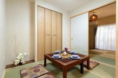 a living room with a wooden table in a room at N102 NEW OPEN IKEBUKURO FREE WiFi MAX7GUESTS in Tokyo