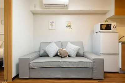 a couch with a stuffed animal on it in a kitchen at N102 NEW OPEN IKEBUKURO FREE WiFi MAX7GUESTS in Tokyo