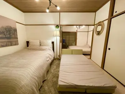 a bedroom with two beds and a mirror at Best Shinjuku Modern Full-furnished Family size Apartment5 ONLY 2min to Shinjuku by Train in Tokyo