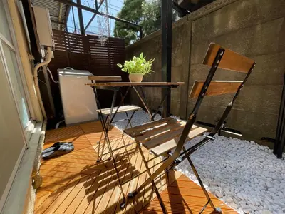 a patio with a table and a chair at Best Shinjuku Modern Full-furnished Family size Apartment5 ONLY 2min to Shinjuku by Train in Tokyo
