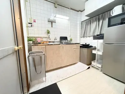 a small kitchen with a sink and a refrigerator at Best Shinjuku Modern Full-furnished Family size Apartment5 ONLY 2min to Shinjuku by Train in Tokyo