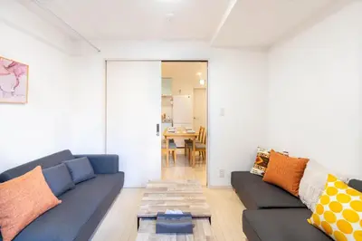a living room with a couch and a table at \u5922\u306e\u5bbf \u7ffc 132t in Tokyo