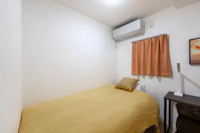 a bedroom with a yellow bed in a room at \u5922\u306e\u5bbf \u7ffc 132t in Tokyo