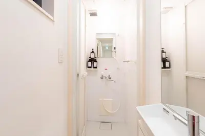 a white bathroom with a shower and a sink at \u5922\u306e\u5bbf \u7ffc 132t in Tokyo
