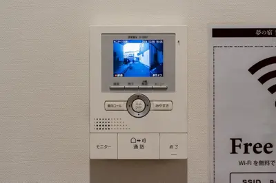 an atm machine with a screen on a wall at \u5922\u306e\u5bbf \u7ffc 132t in Tokyo
