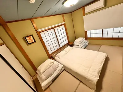 a small room with a bed and a window at \u5317\u5343\u4f4f\u306e\u4e00\u8ed2\u5bb6\uff4b3 in Tokyo