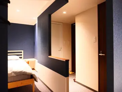 a bedroom with a bed and a mirror at ForYou Honancho \u65b9\u5357\u753a in Tokyo