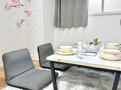 a table with plates and bowls on it in a room at Shinjuku Waseda home4 in Tokyo