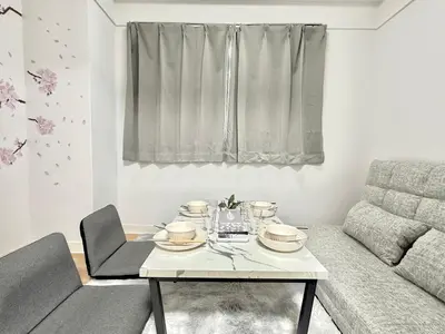 a living room with a table and a couch at Shinjuku Waseda home4 in Tokyo