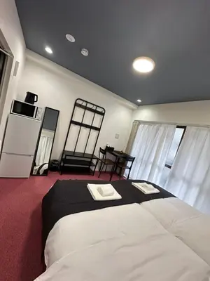 a bedroom with a large bed with two towels on it at \u798f\u30db\u30c6\u30eb401 in Tokyo