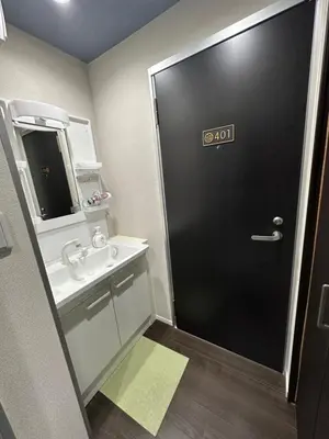 a bathroom with a black door and a sink at \u798f\u30db\u30c6\u30eb401 in Tokyo