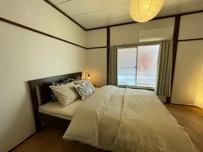 a bedroom with a large bed and a window at \u548c\u98a8\u5c0f\u7b51\u3068\u4eac\u753a\u5c4b in Tokyo