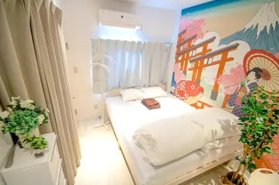 a room with a bed with a painting on the wall at 10min Meguro Sta 18min Shibuya Sta Max2 SAKURA meguro203 in Tokyo