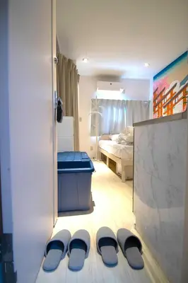a room with a bed and a pair of slippers at 10min Meguro Sta 18min Shibuya Sta Max2 SAKURA meguro203 in Tokyo