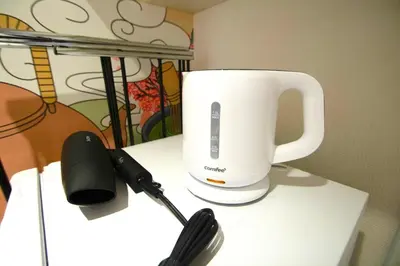 a coffee cup on a table next to a phone at 10min Meguro Sta 18min Shibuya Sta Max2 SAKURA meguro203 in Tokyo