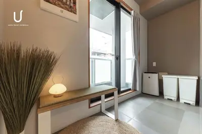 a room with a table with a lamp and a window at Hotel Residence Asakusa by unito in Tokyo