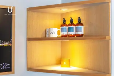 a shelf with bottles and mugs on it at Hotel Residence Asakusa by unito in Tokyo