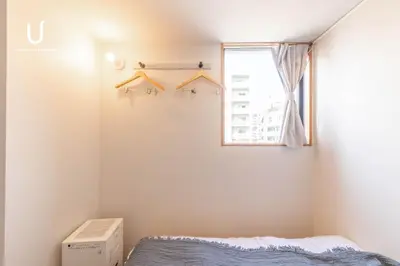a bedroom with a bed and a window at Hotel Residence Asakusa by unito in Tokyo