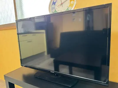 a computer monitor sitting on a table with a clock at Tokyo Stay Apila in Tokyo