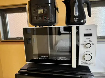 a microwave with a coffee pot on top of it at Tokyo Stay Apila in Tokyo