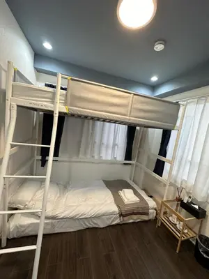 a bedroom with two bunk beds in a room at \u798f\u30db\u30c6\u30eb402 in Tokyo