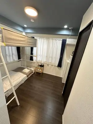 a small room with a bunk bed and a staircase at \u798f\u30db\u30c6\u30eb402 in Tokyo