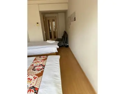 a room with two beds and a rug on the floor at ARSTAY Ikebukuro - Vacation STAY 65934v in Tokyo