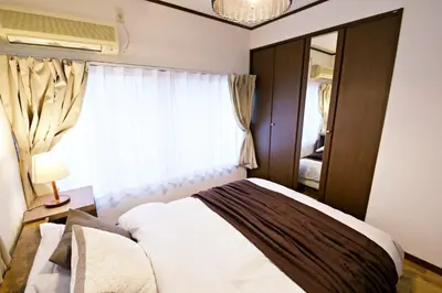a small bedroom with a bed and a window at Muse\u516b\u5e832F in Tokyo