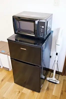 a microwave oven sitting on top of a refrigerator at Muse\u516b\u5e832F in Tokyo