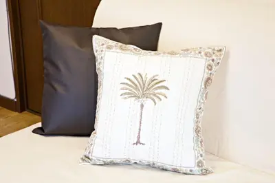 a pillow with a palm tree on it on a bed at Muse\u516b\u5e832F in Tokyo