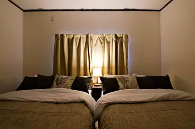 two beds sitting in a room with a window at Muse\u516b\u5e832F in Tokyo