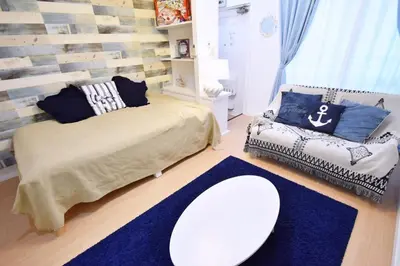 a bedroom with a bed and a couch and a table at \u6771\u30b0\u30ea\u30fc\u30f3\u30cf\u30a4\u30c4 302 in Tokyo
