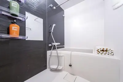 a bathroom with a shower with a toilet and a sink at Ueno Grand Maison Hotel in Tokyo