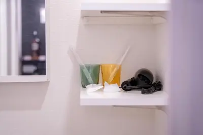 a shelf in a bathroom with two cups on it at Ueno Grand Maison Hotel in Tokyo