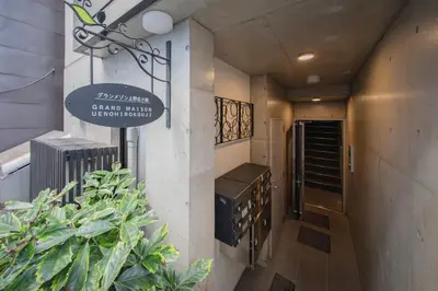 a sign on the side of a building with plants at Ueno Grand Maison Hotel in Tokyo