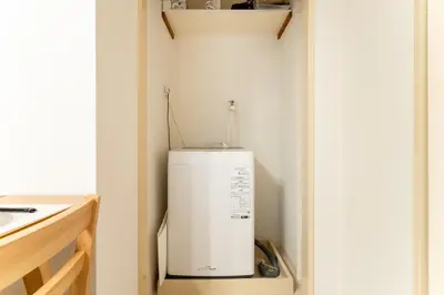 a small refrigerator in a corner of a room at Japanese Art Room, 2Bed Room, 4Bed, Near Metro&JR station in Tokyo