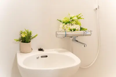 a white toilet with flowers on top of it at Japanese Art Room, 2Bed Room, 4Bed, Near Metro&JR station in Tokyo