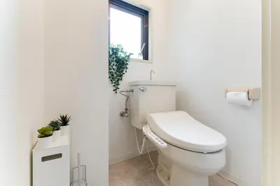 a white bathroom with a toilet and a window at Japanese Art Room, 2Bed Room, 4Bed, Near Metro&JR station in Tokyo