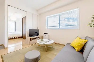 a living room with a couch and a table at Emilio Nishi Shinjuku in Tokyo